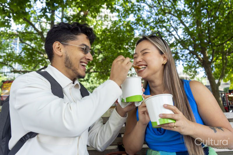 Tourist couple eating street food