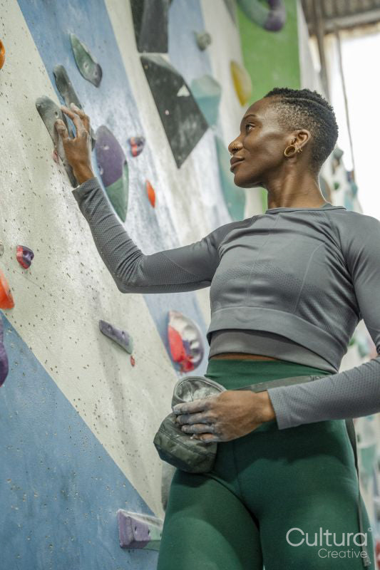 Athletic woman at climbing wall at gym