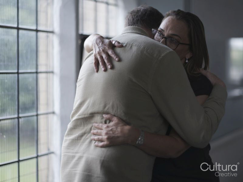 Man and woman hugging in therapy session