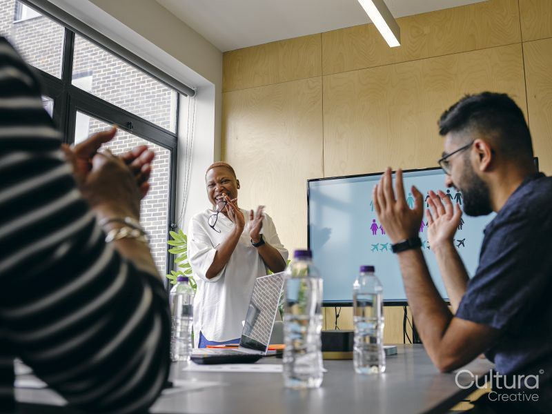 People clapping hands during business meeting