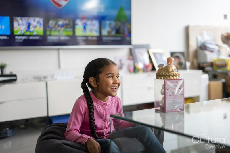 Girl sitting at table in living room