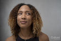Portrait of woman with curly hair and brown eyes