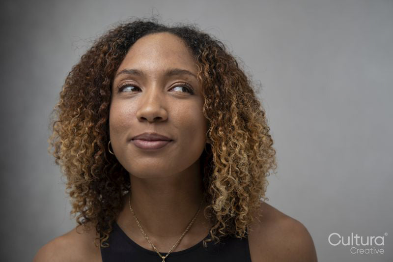 Portrait of woman with curly hair and brown eyes