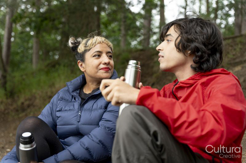 Mother and son relaxing in forest