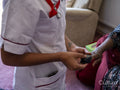 Nurse taking care of elderly woman, measuring oxygen saturation