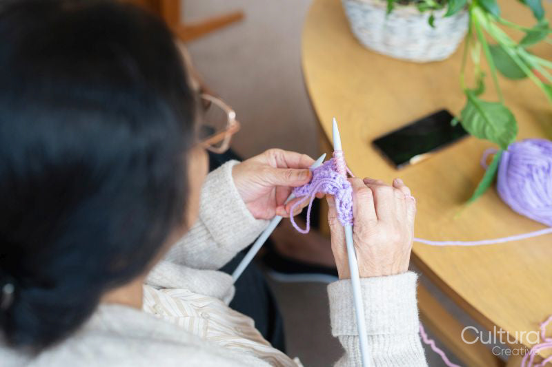 Senior woman knitting in nursing home