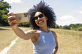 Young woman taking selfie in rural setting