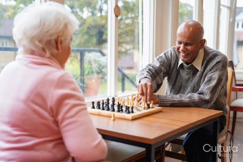 Senior people playing chess in nursing home