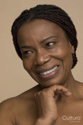 Studio portrait of smiling mature woman with braided hair