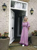 Smiling mature woman standing at front door