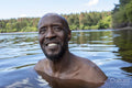 Portrait of smiling man in lake, Yorkshire, UK