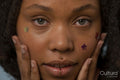 Portrait of young woman wearing star stickers on face