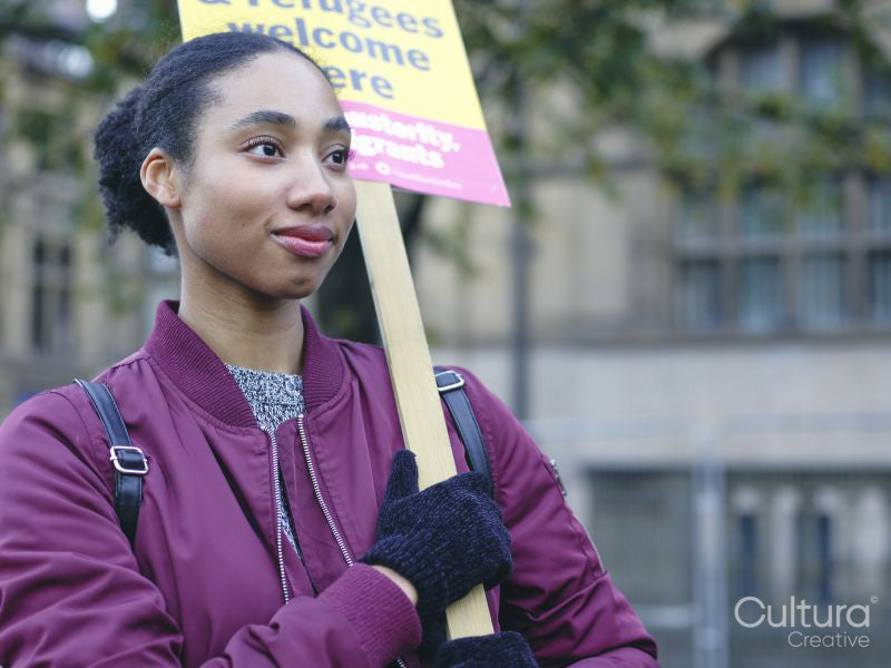 Portrait of woman protesting with placard