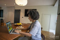 Smiling woman using laptop at home