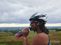 Female cyclist drinking from water bottle