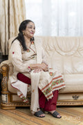 Cheerful senior woman sitting on sofa in living room
