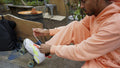 Young man tying shoelace on roller skate