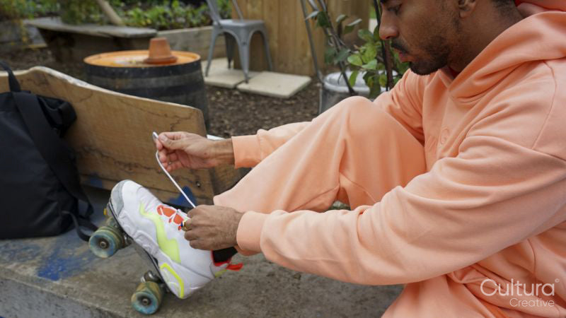 Young man tying shoelace on roller skate