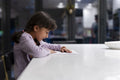 Little girl reading at table