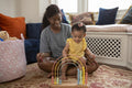 Mother playing with baby daughter at home