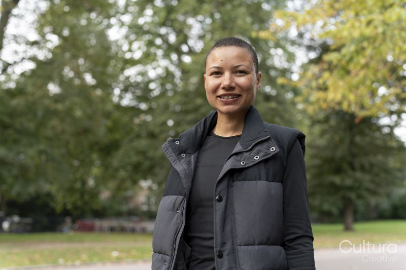 Portrait of smiling woman in sports clothing in park