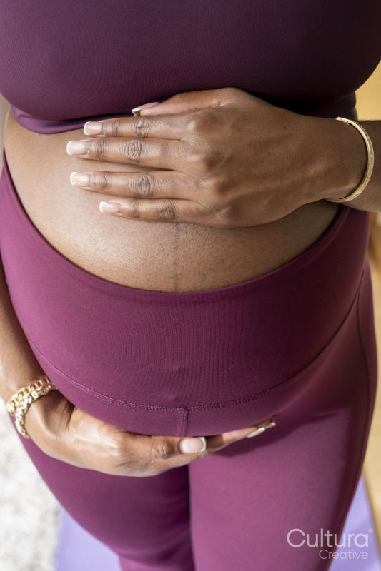 Pregnant woman touching abdomen
