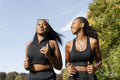 Young female friends jogging in park