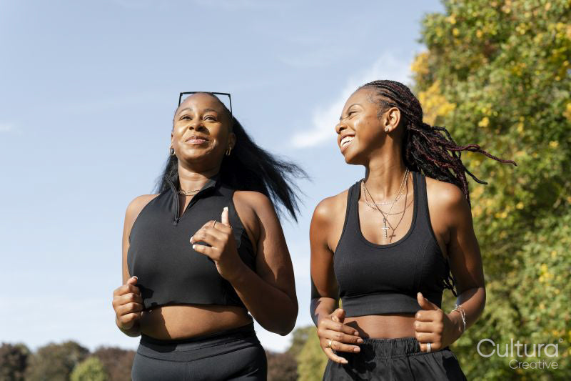 Young female friends jogging in park