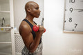 Mature woman exercising at home with dumbbells