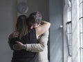 Man and woman hugging in therapy session