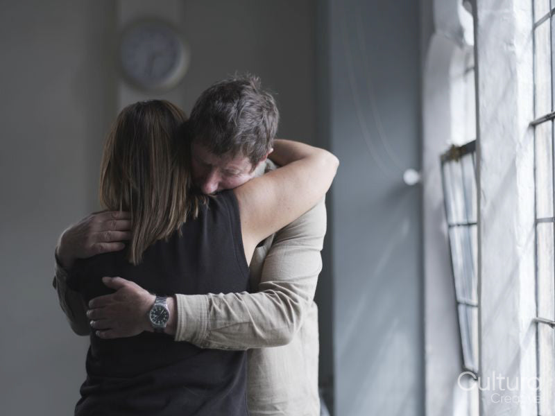 Man and woman hugging in therapy session