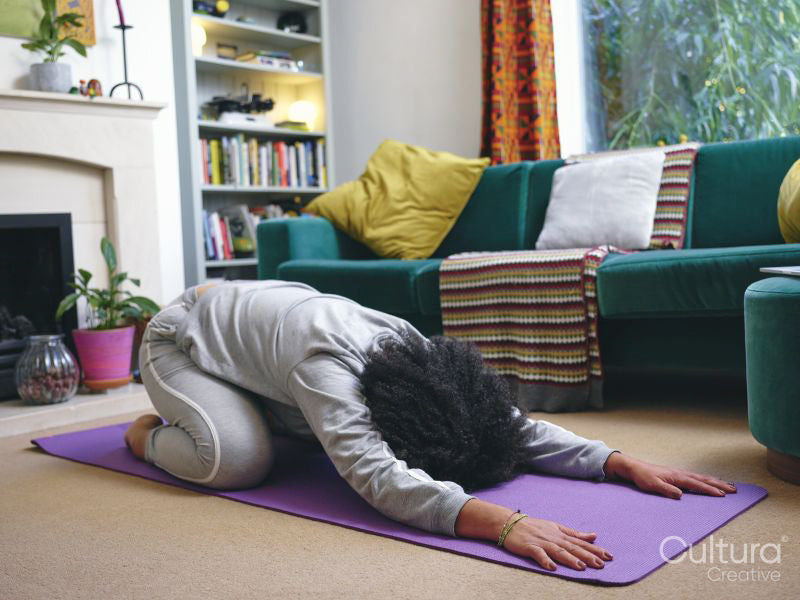 Woman practicing yoga at home