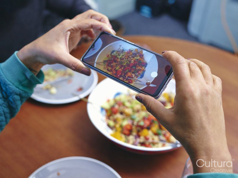 Woman taking picture of lunch with smart phone