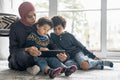 Mother and sons using digital tablet at home