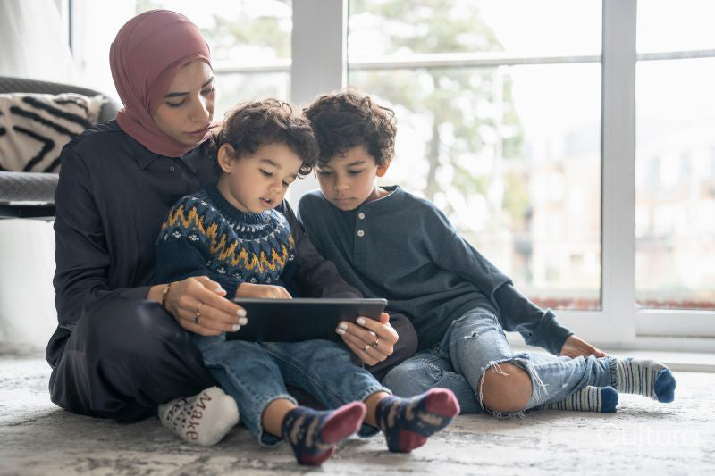 Mother and sons using digital tablet at home