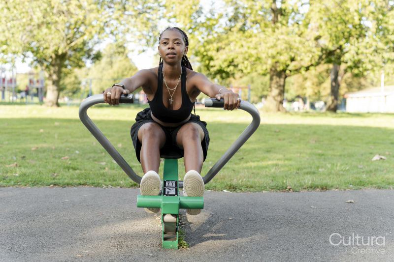 Young woman exercising in outdoor gym