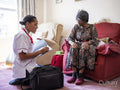 Elderly woman talking with nurse