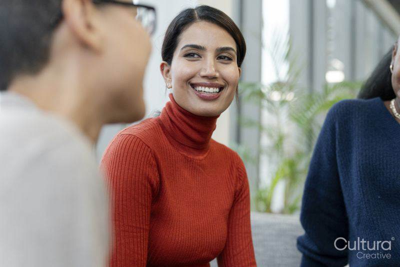 Coworkers having meeting in office lobby