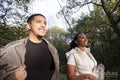Portrait of smiling couple walking in forest