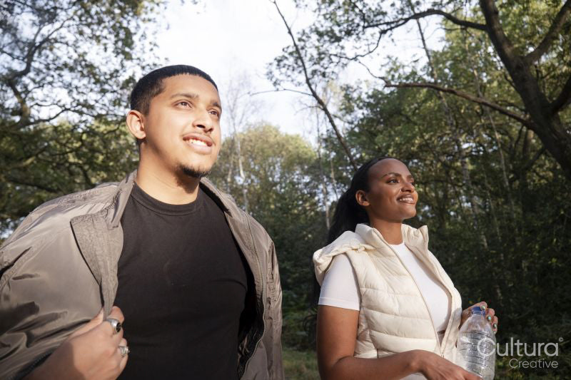 Portrait of smiling couple walking in forest