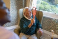 Smiling senior man playing with racket in nursing home