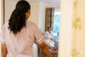 Nurse visiting senior lady in her room at nursing home
