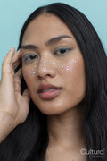 Young woman with black hair, wearing glittery freckles