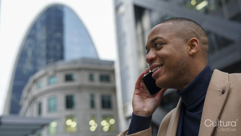 Business man using phone in city