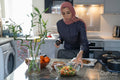 Woman in hijab preparing meal at home