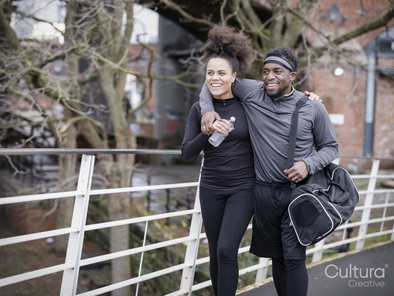 Smiling athletic couple walking outdoors