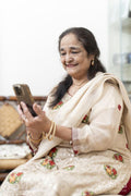 Portrait of senior woman using smart phone in living room