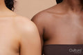 Studio portrait of diverse women arm in arm