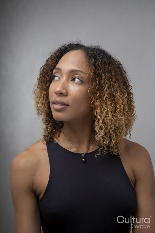 Portrait of woman with curly hair and brown eyes