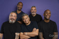 Portrait of smiling men in black t-shirts against purple background
